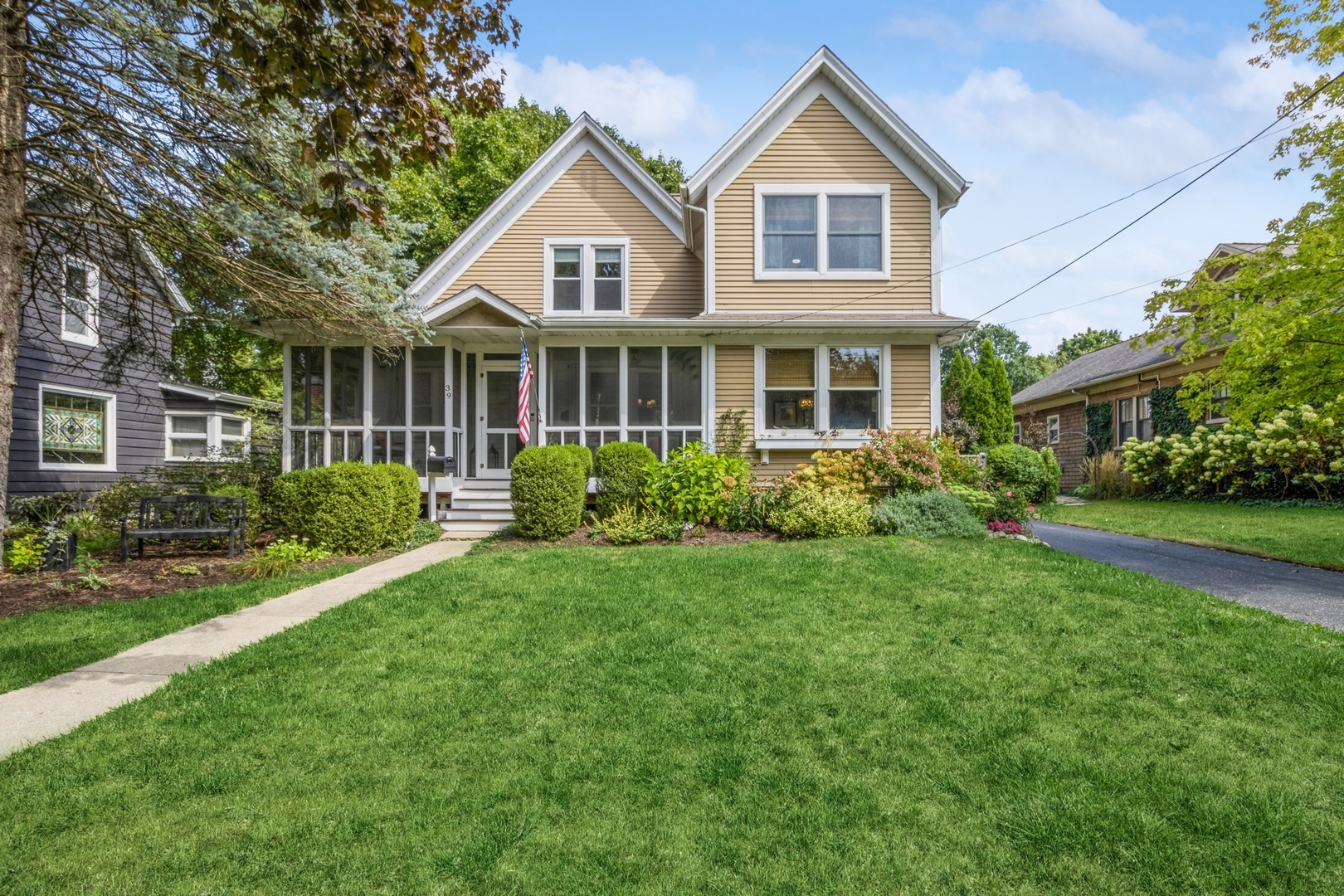 a front view of a house with a yard and trees