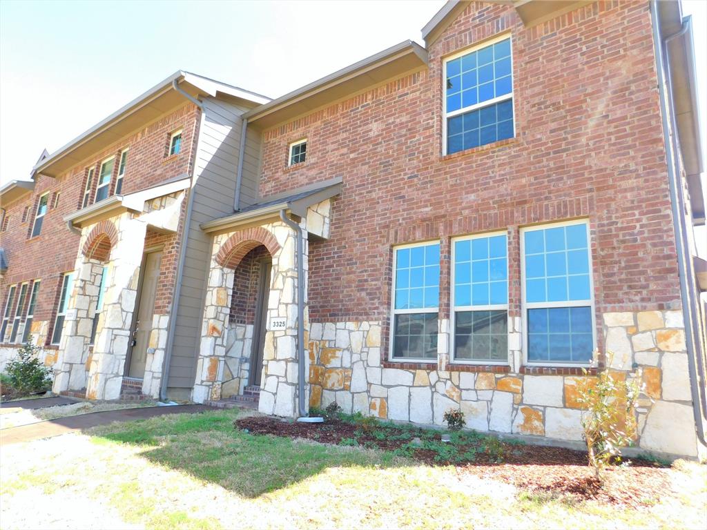 a view of a brick building with many windows