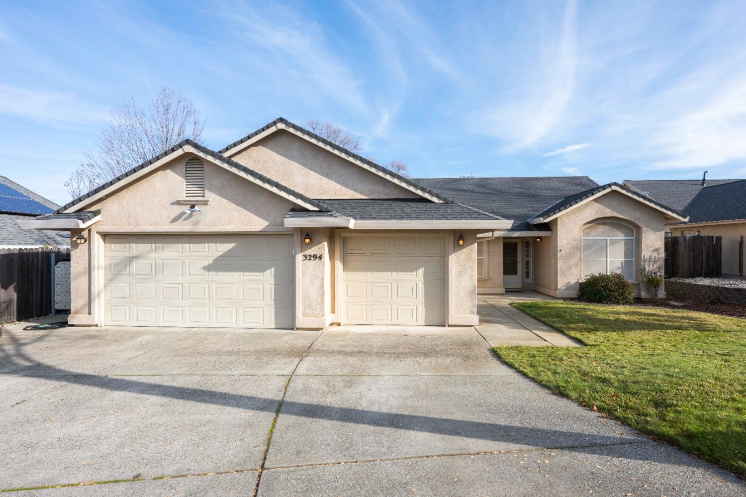 a view of a house with a yard and garage