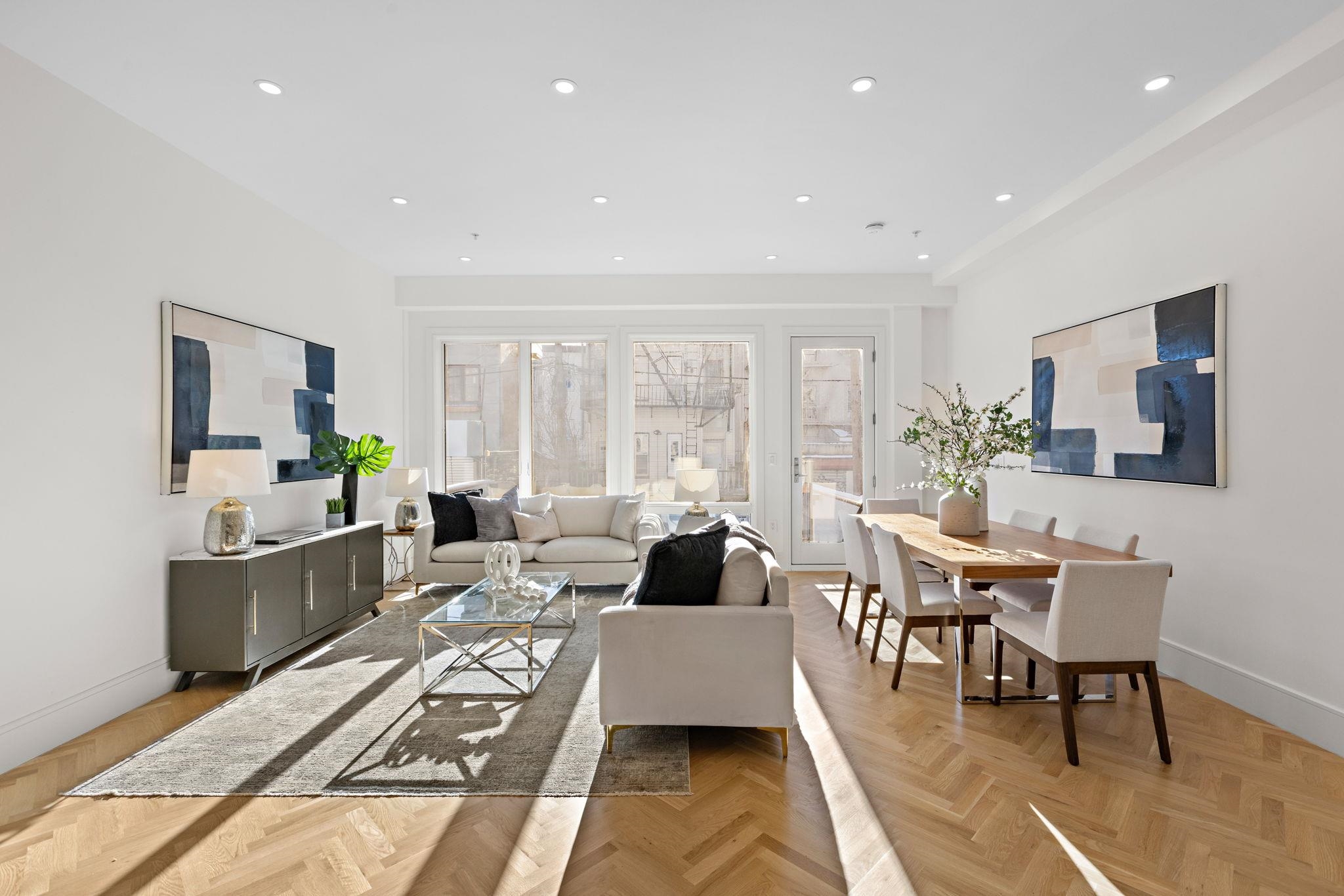 a living room with furniture wooden floor and a flat screen tv