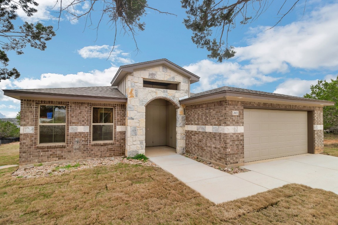 a front view of a house with a yard and garage