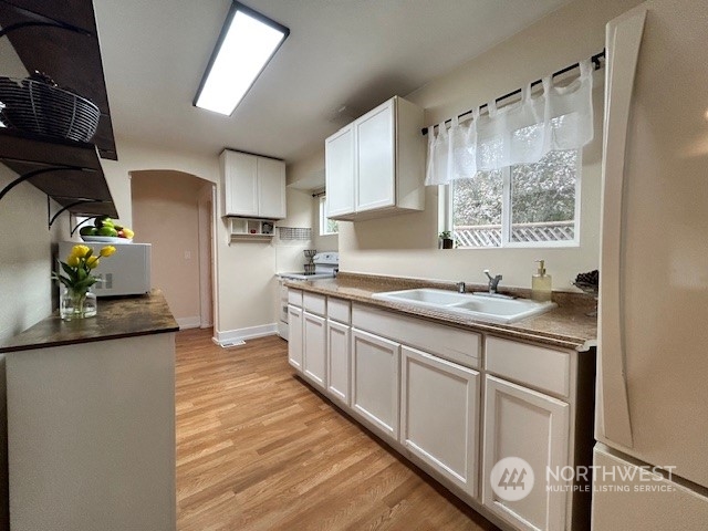 a kitchen with granite countertop a sink stainless steel appliances and cabinets