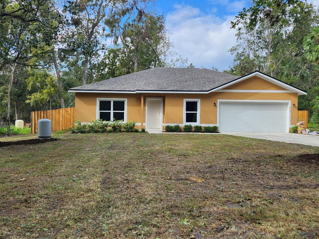 a front view of house with yard and trees