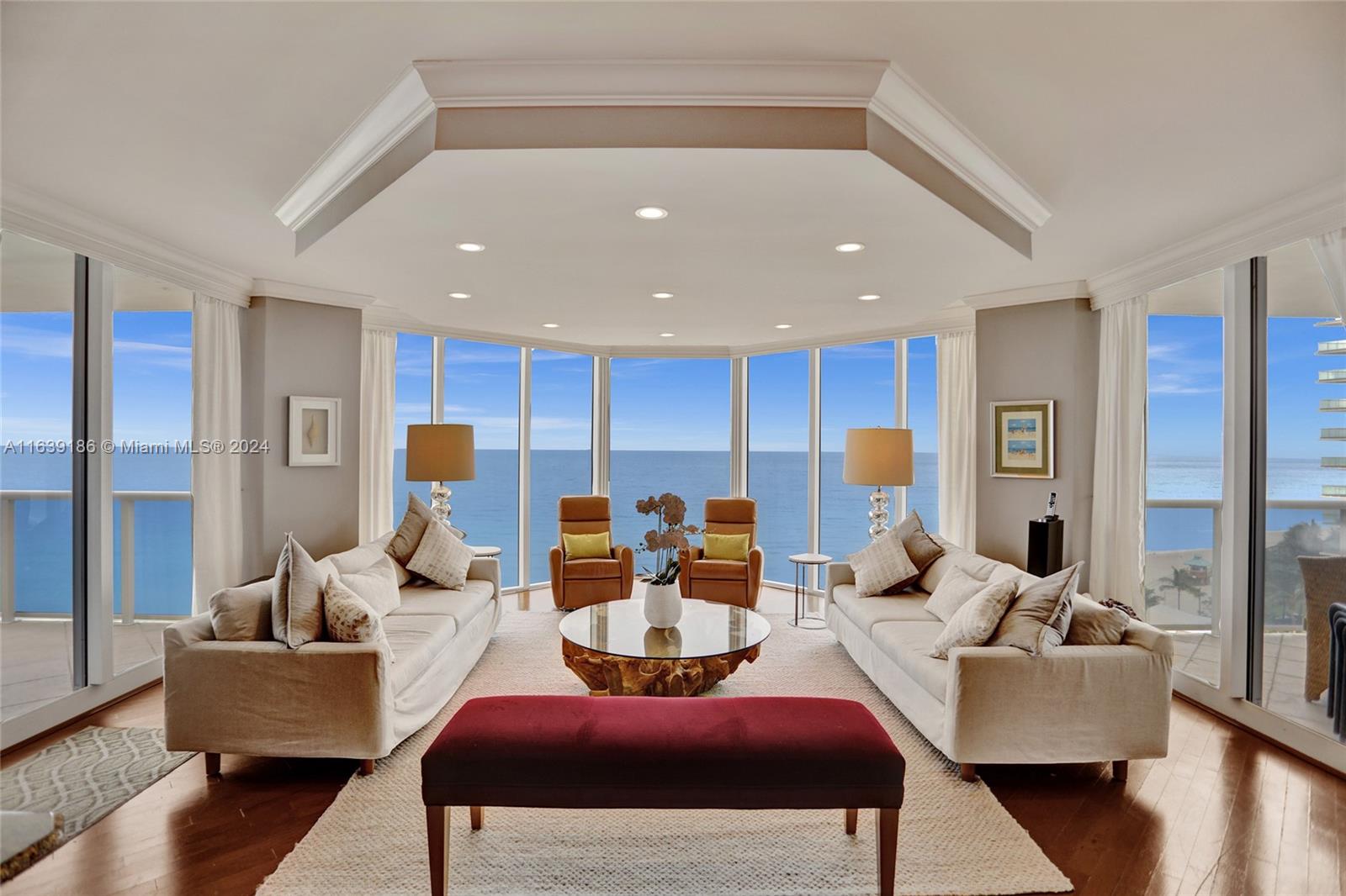 a living room with furniture kitchen view and a large window