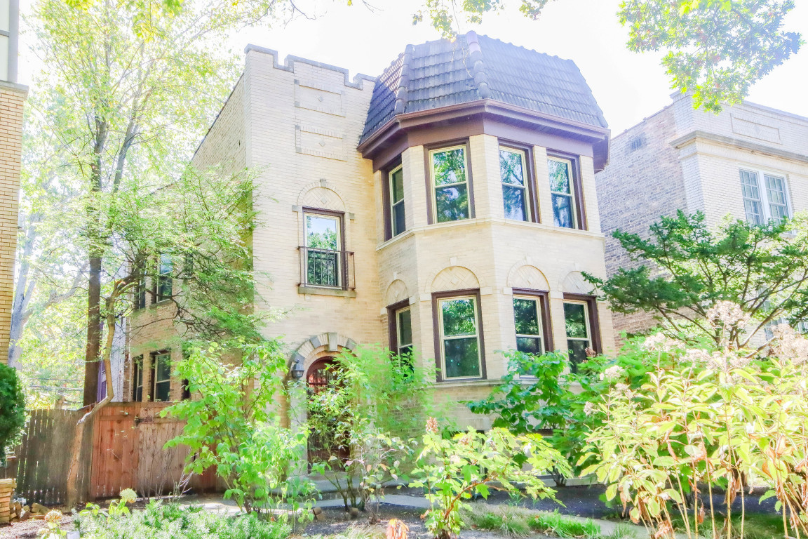 front view of a brick house with a large windows