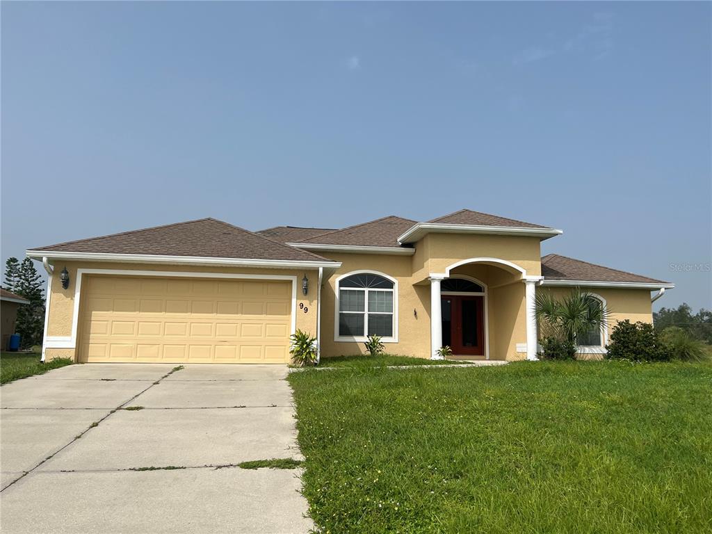 a front view of a house with a yard and garage