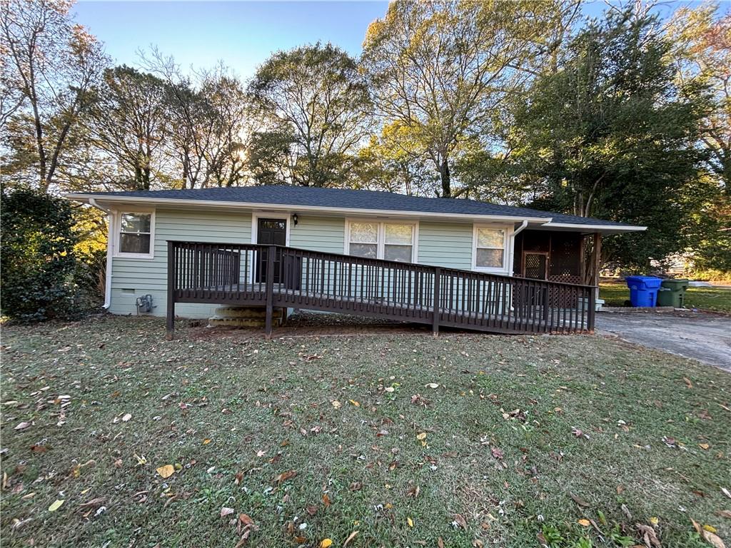 a view of backyard with deck and backyard