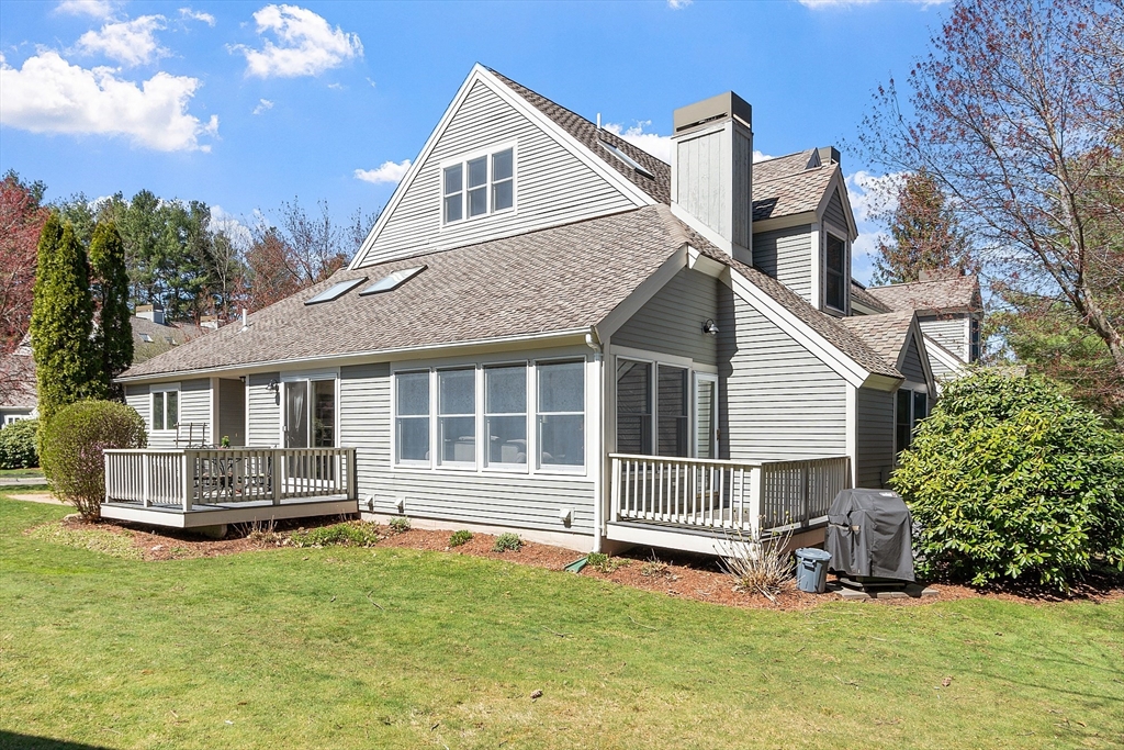 a view of a house with a yard and sitting area