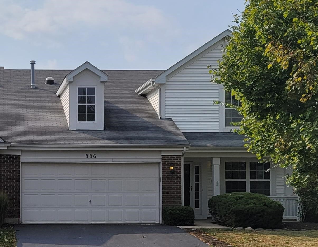 a front view of a house with a garage