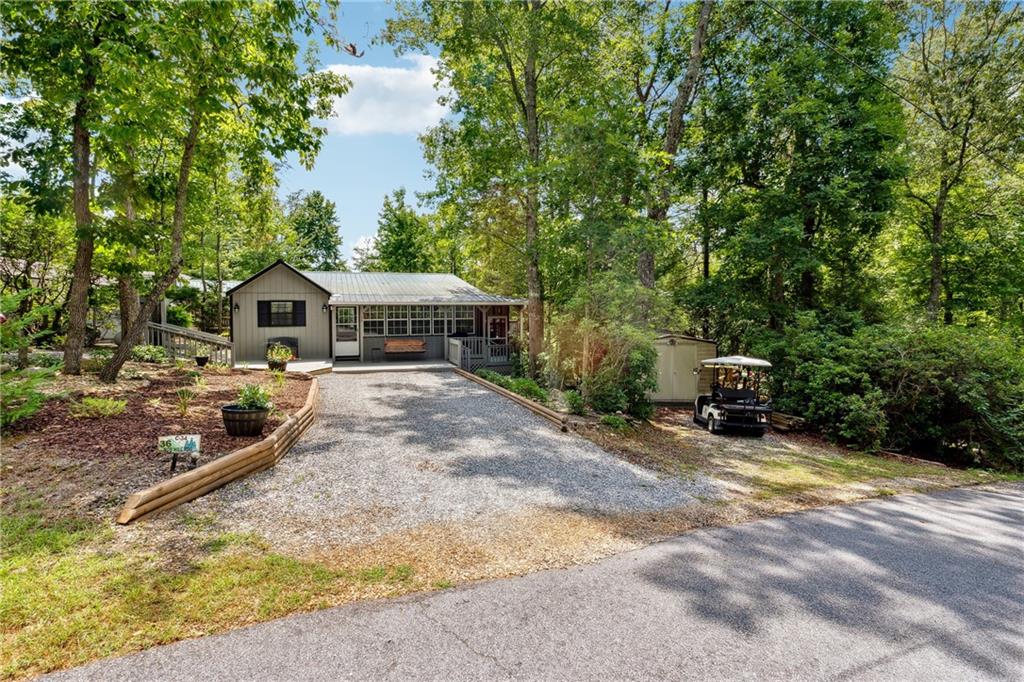 a view of house with yard outdoor seating and barbeque oven