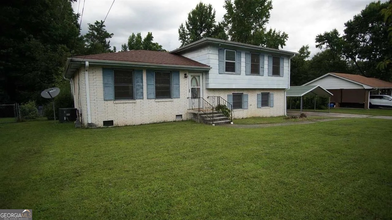 a front view of a house with a garden