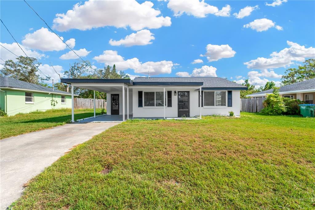 a view of a house with a backyard