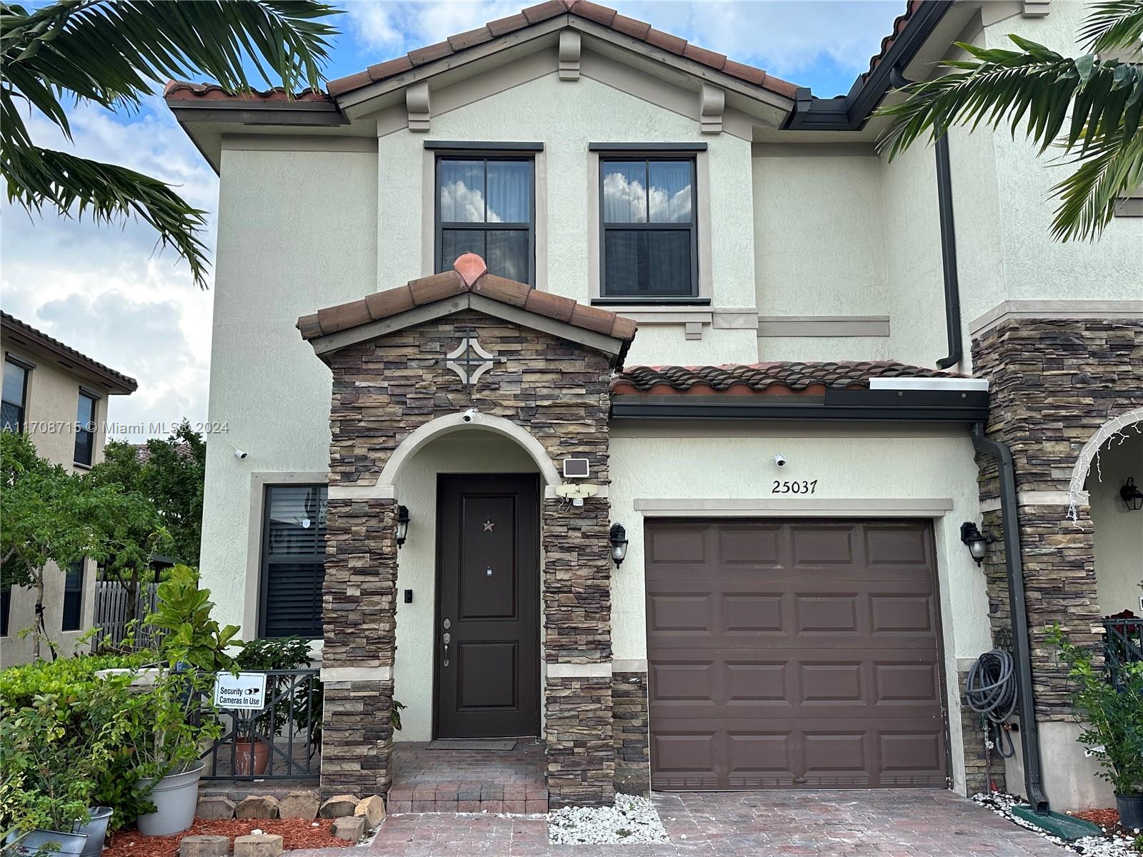 a front view of a house with garage