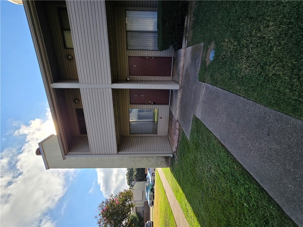 a view of a house with garden and yard