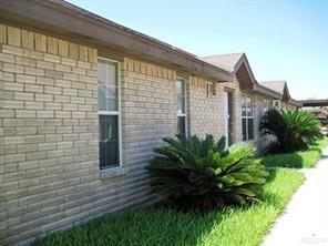 a brick building with a yard