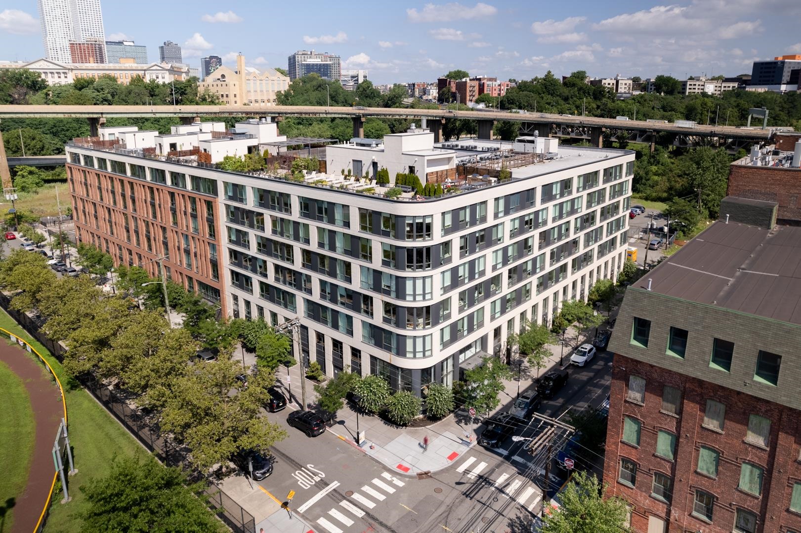 a view of roof deck with outdoor seating and city view