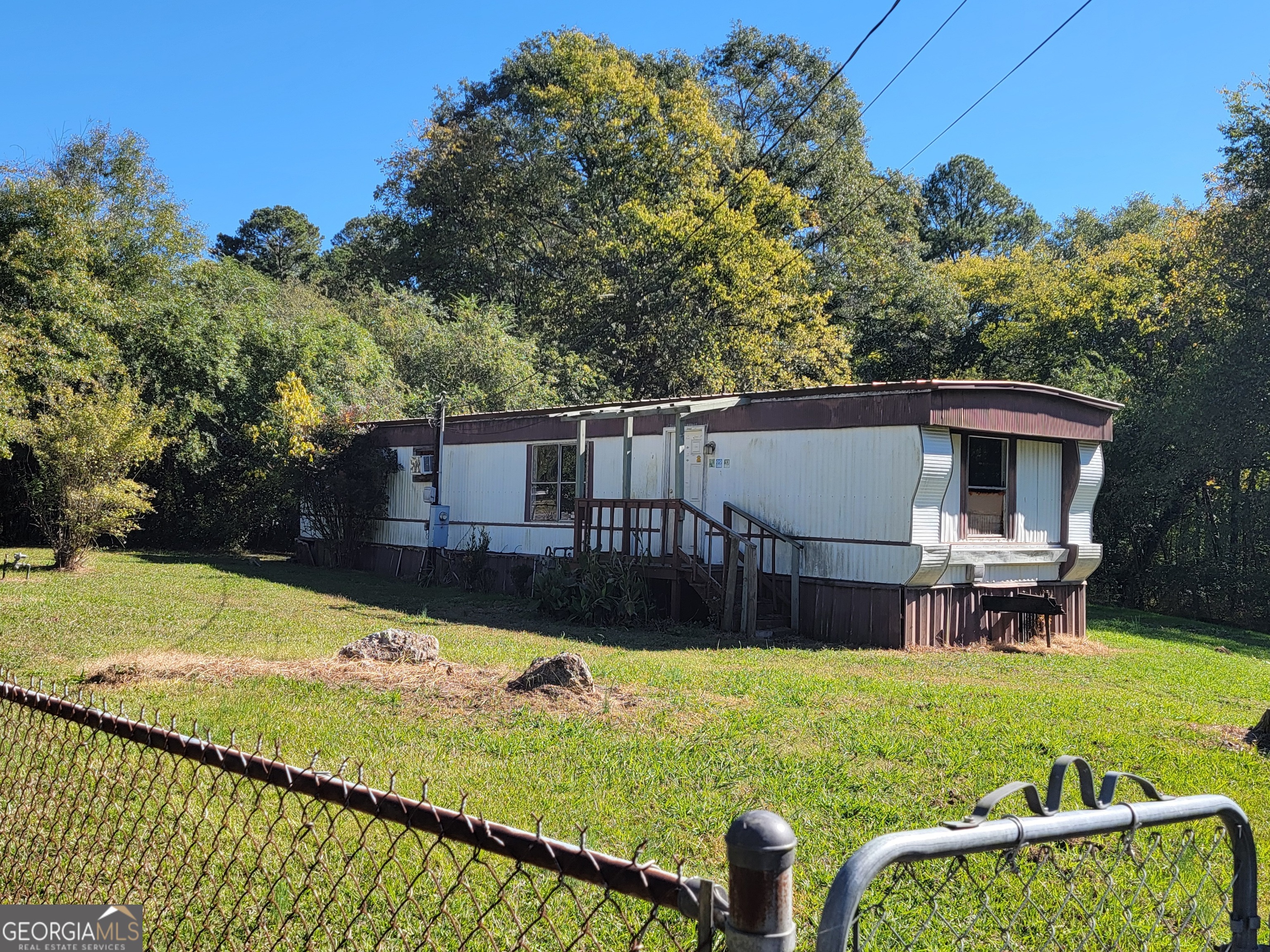 a view of house with backyard and a garden