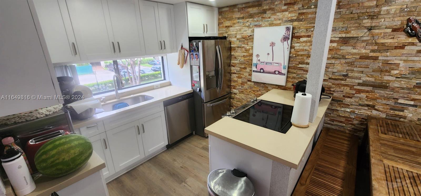 a kitchen with a sink a refrigerator and window