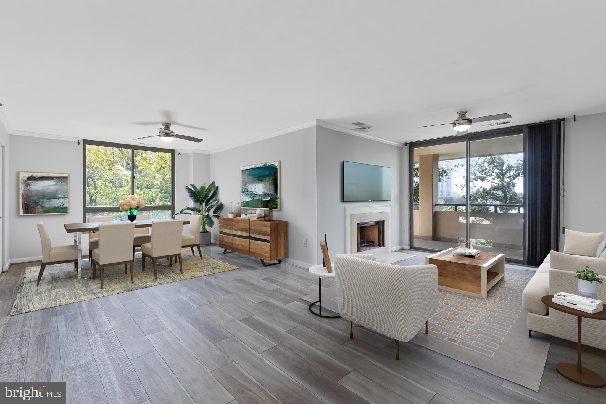 a living room with fireplace furniture and a large window