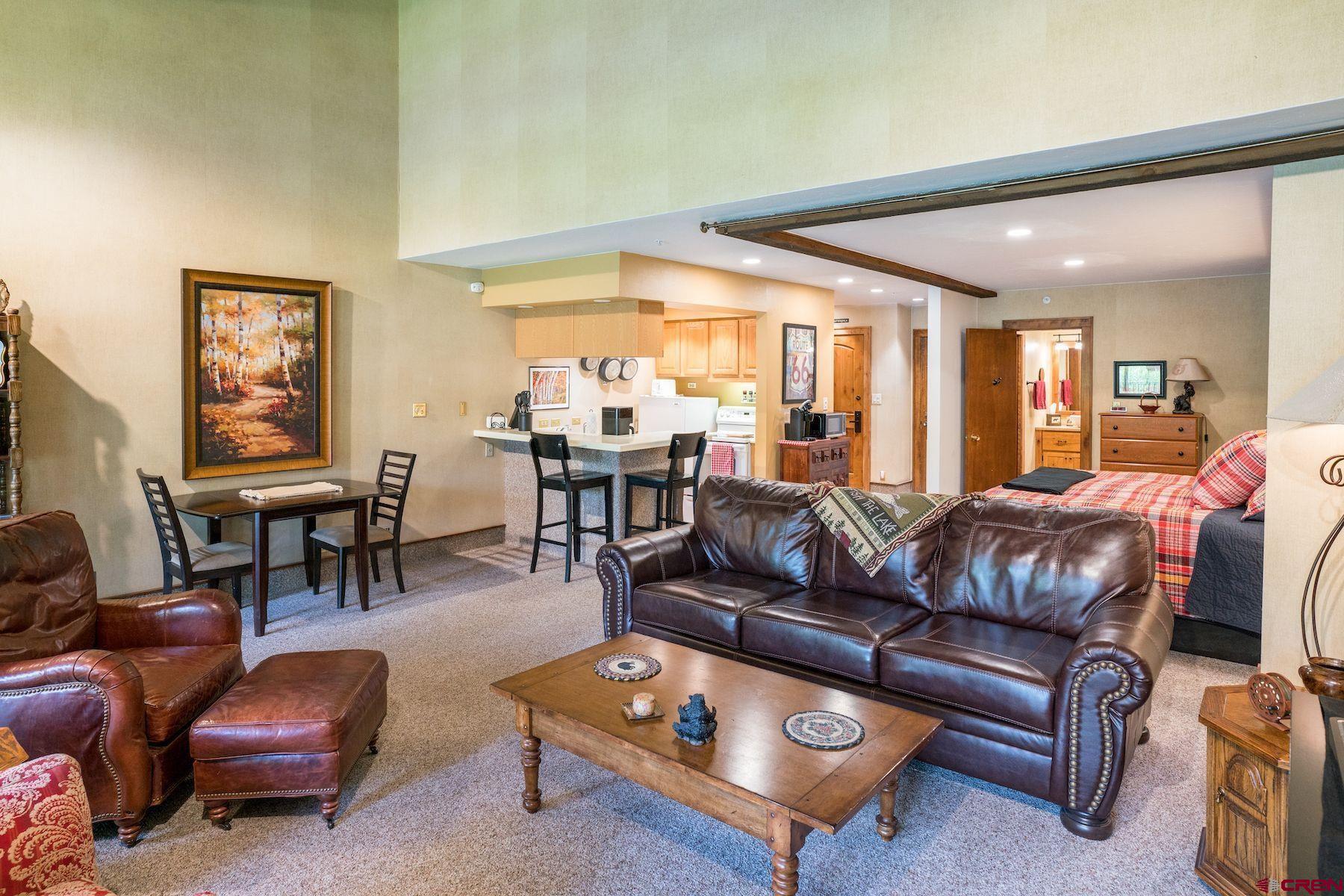 a living room with furniture a rug and a large window