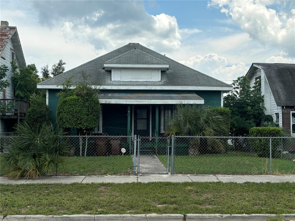 a front view of a house with plants