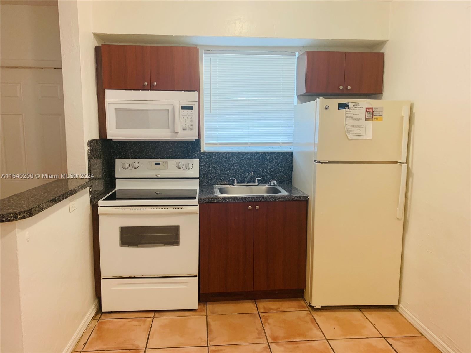 a kitchen with a refrigerator and a stove