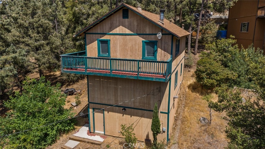 a view of a small house with roof deck