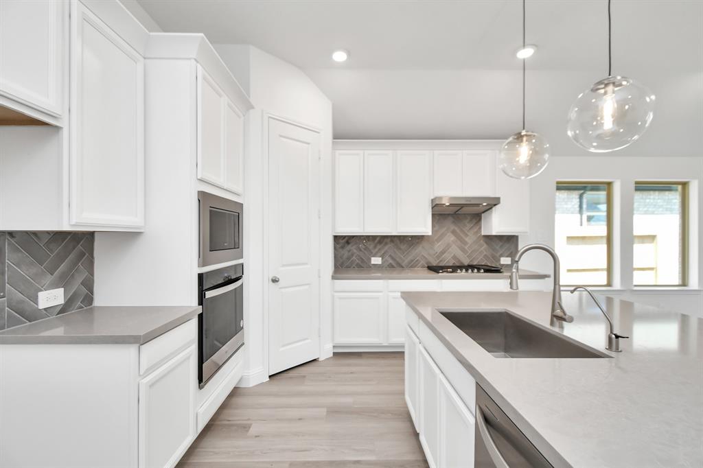 a kitchen with a sink stove and refrigerator