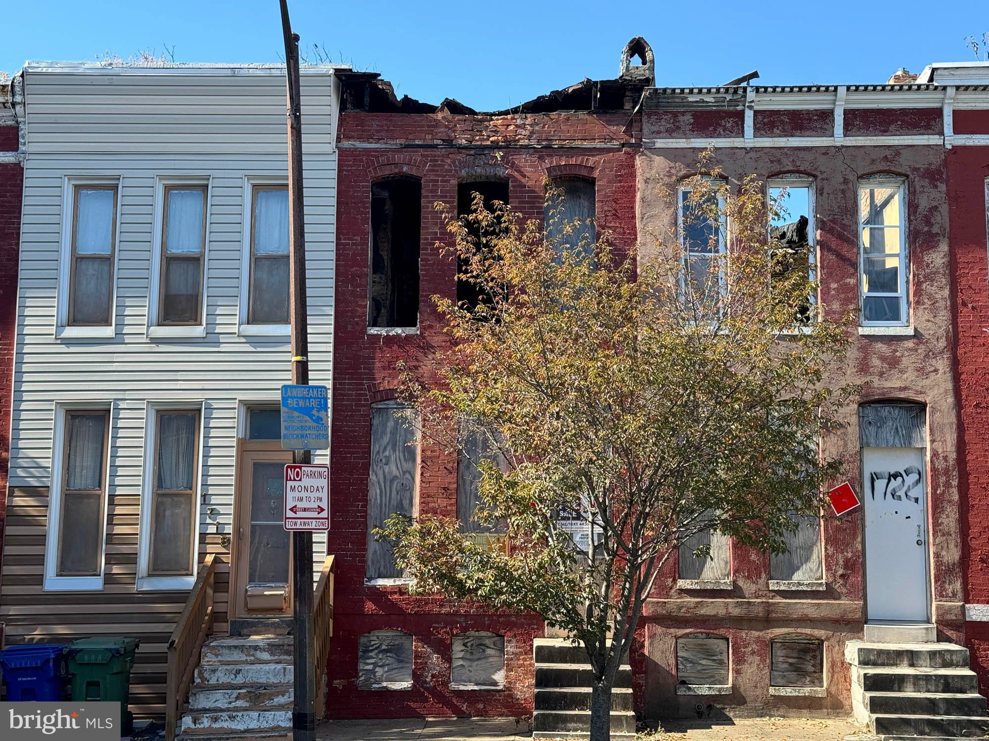 front view of a house with a tree