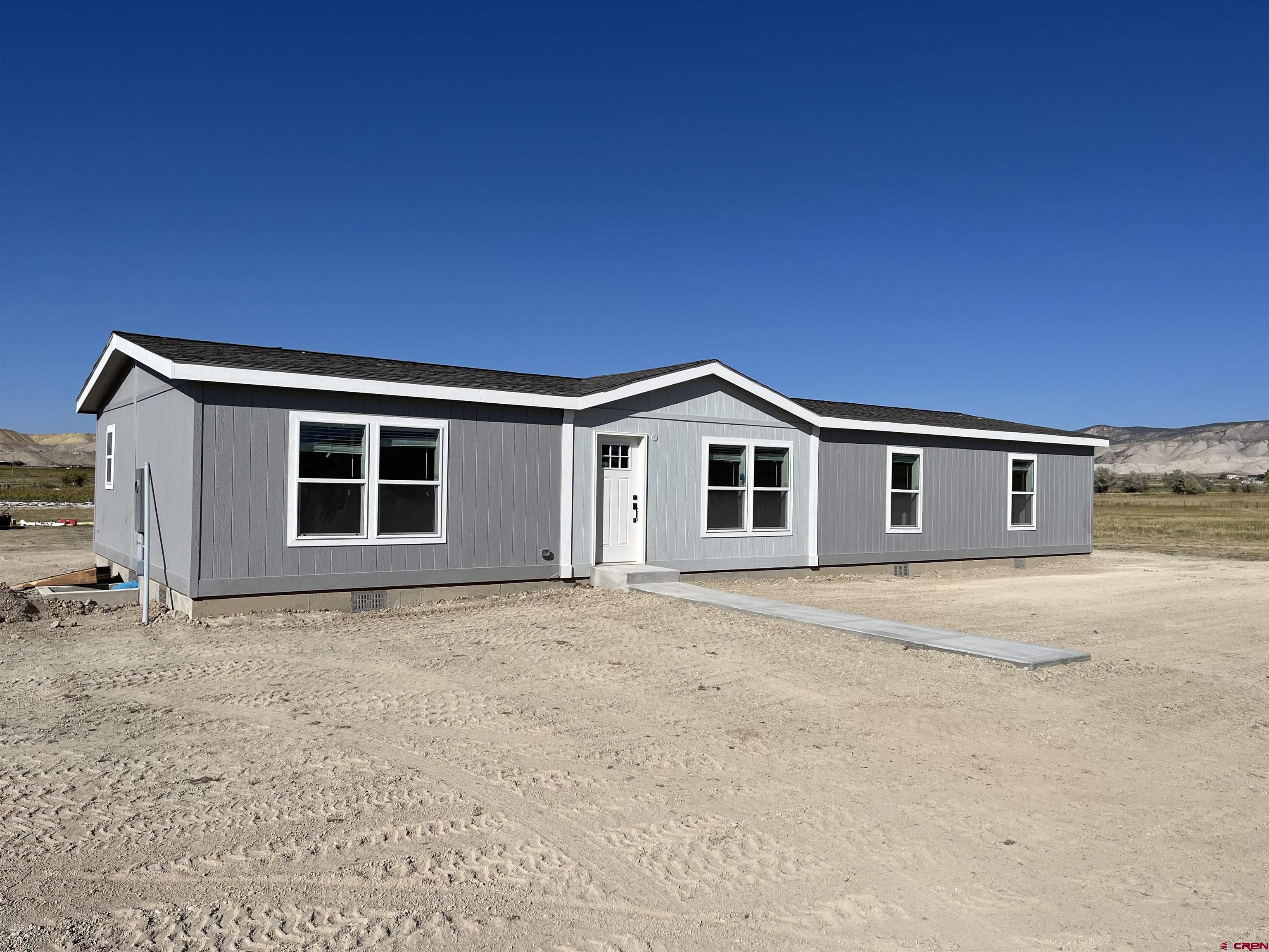 a view of house with garage and yard