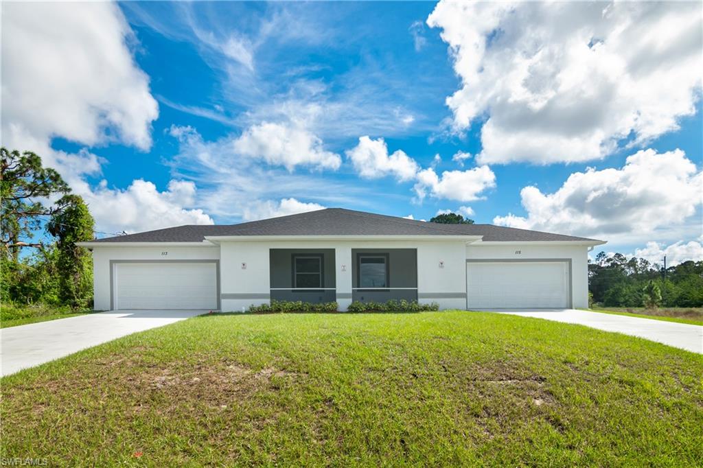 a front view of house with yard and green space