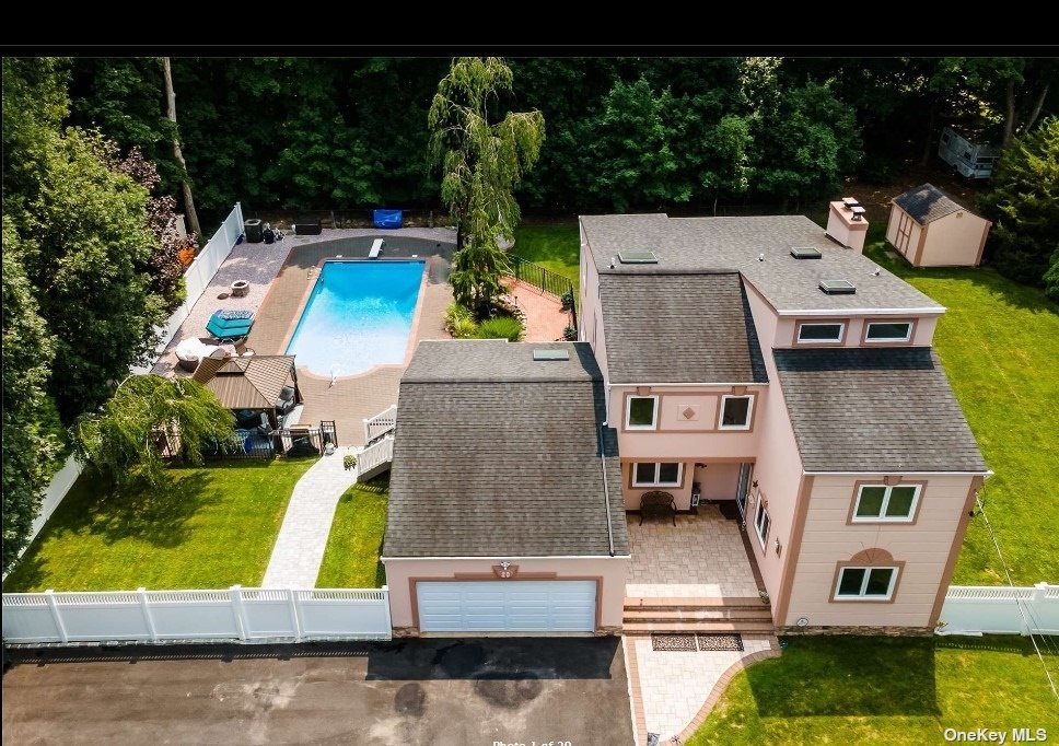 an aerial view of residential houses with outdoor space and swimming pool