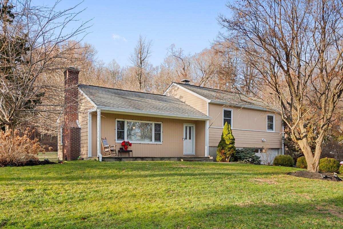 a front view of house with yard and trees