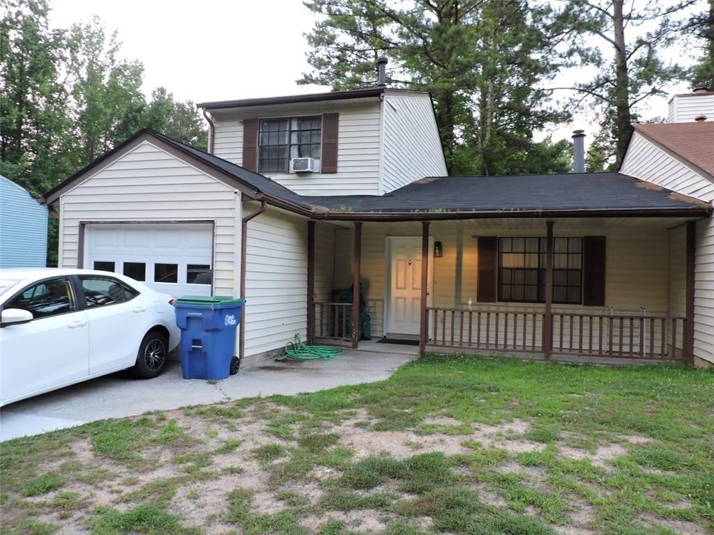 a view of a house with a yard and wooden fence