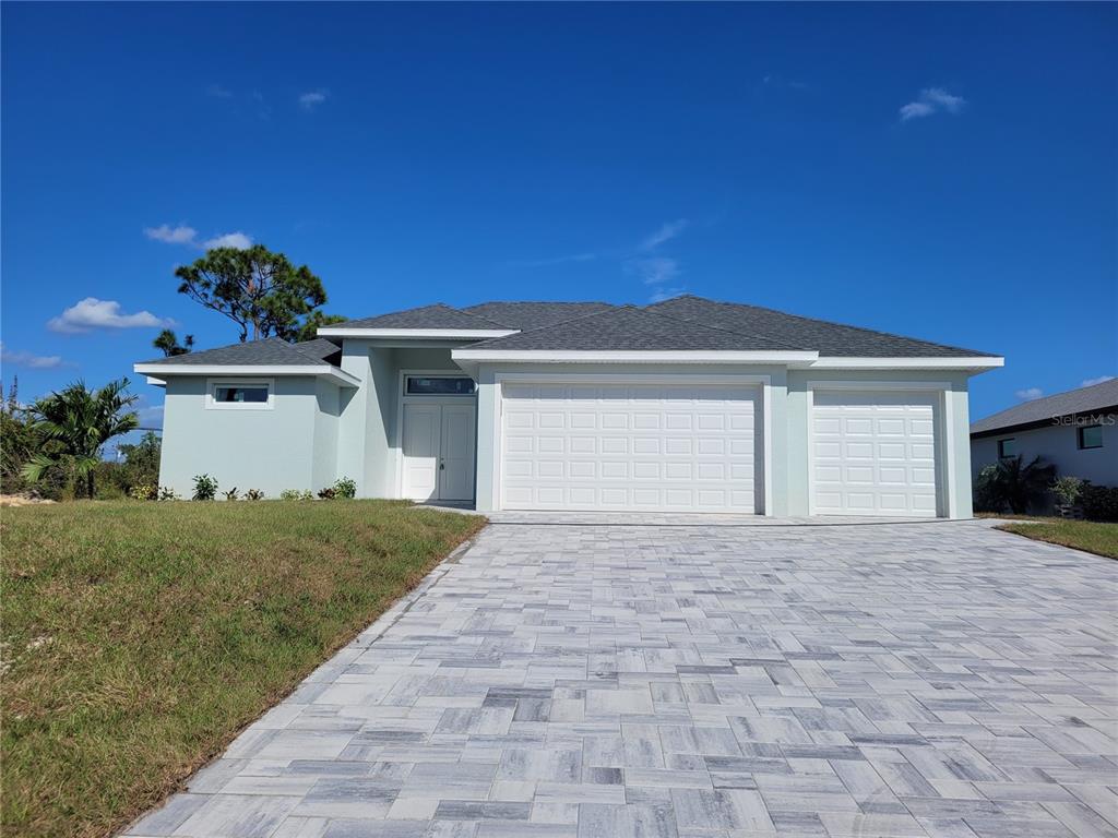 a view of backyard of house with garage and yard