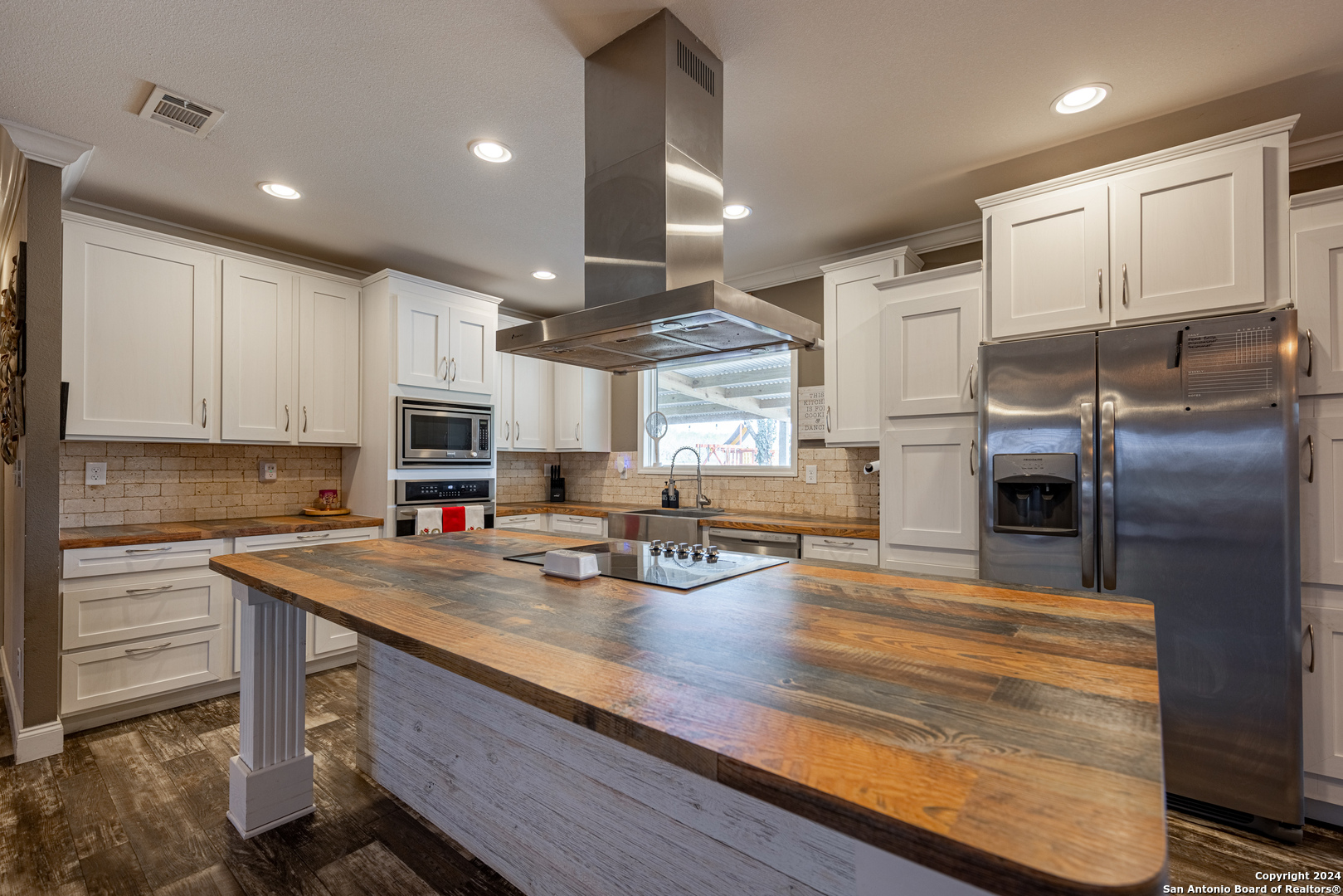 a kitchen with kitchen island a counter appliances and cabinets