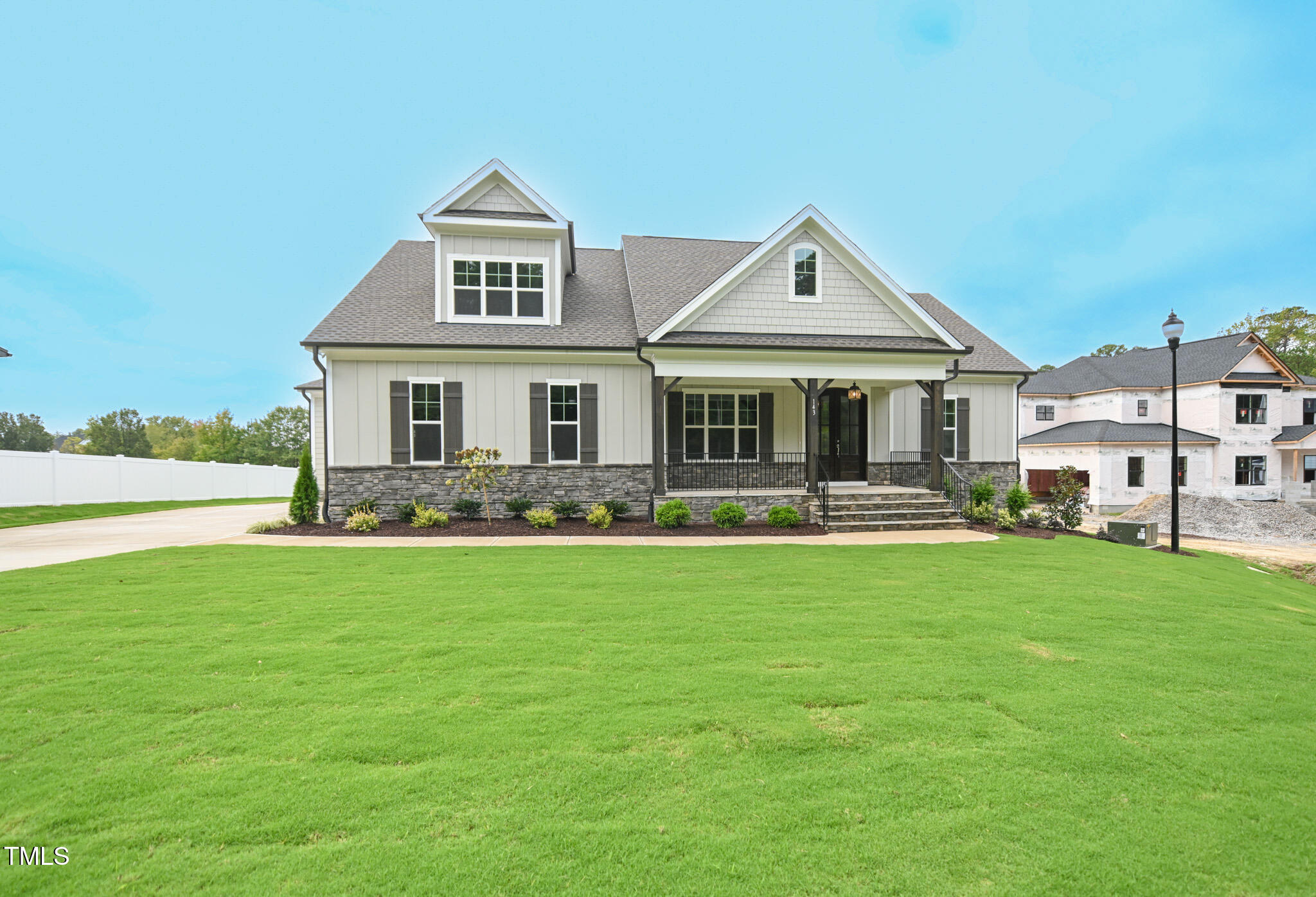 a front view of a house with yard and green space