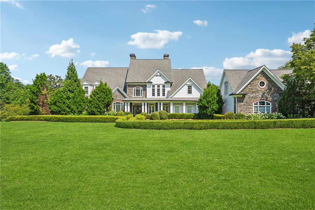 a front view of house with yard and green space