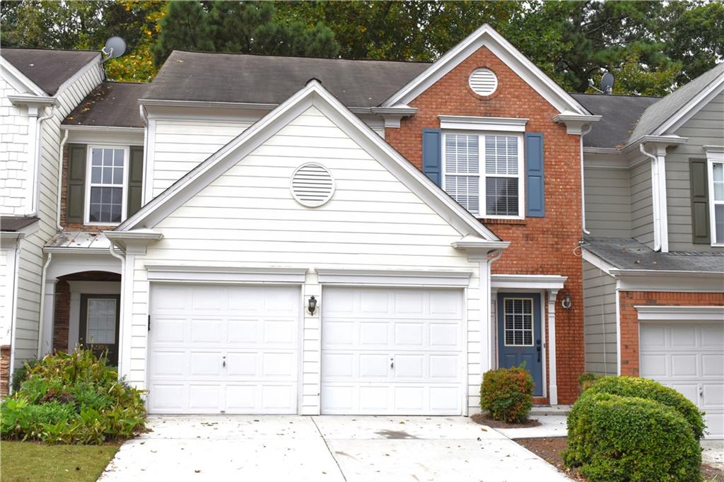 a view of a brick house with large windows