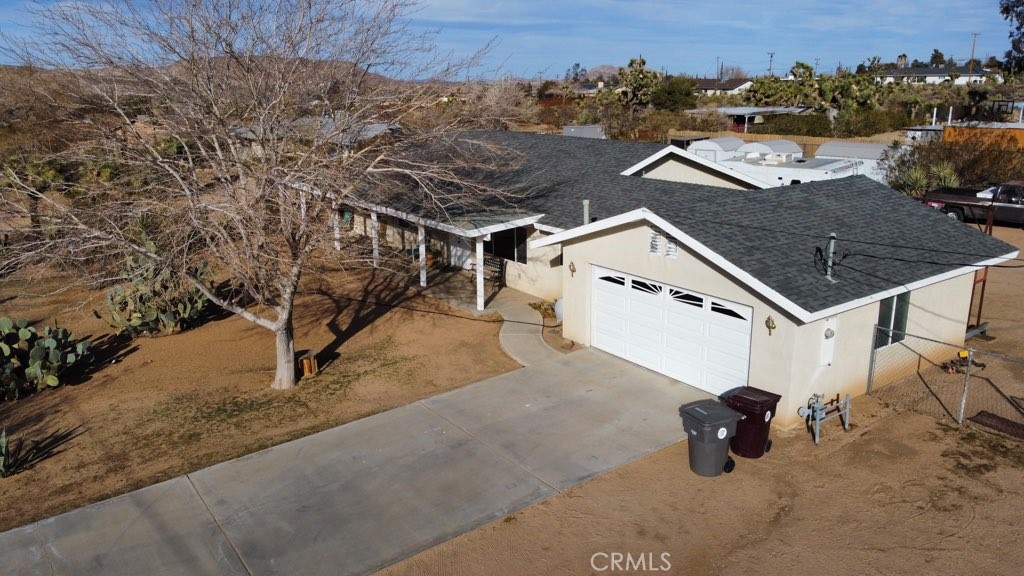 an aerial view of residential house with parking area