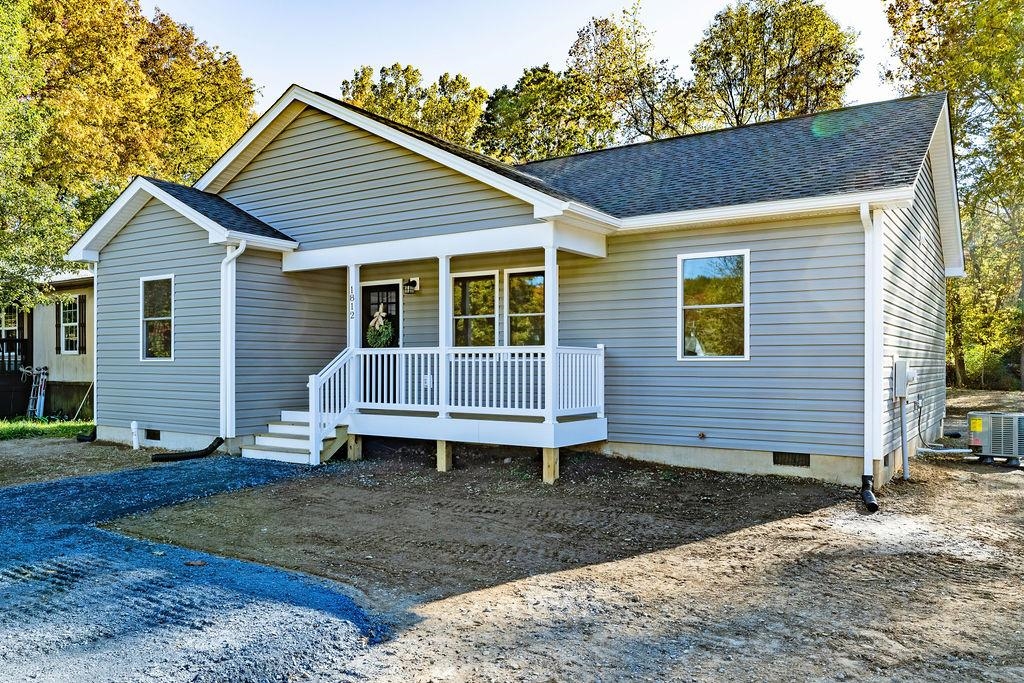 a view of a house with a yard and stairs