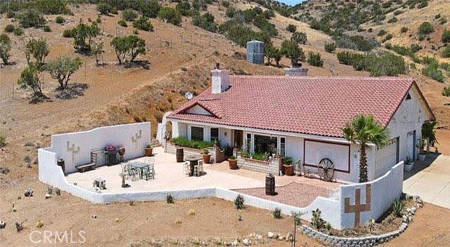 a view of a house with backyard porch and sitting area