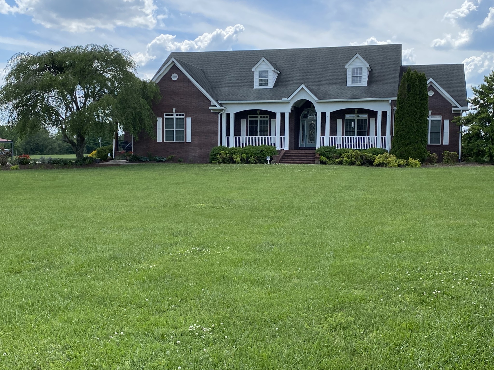 a front view of house with yard and green space