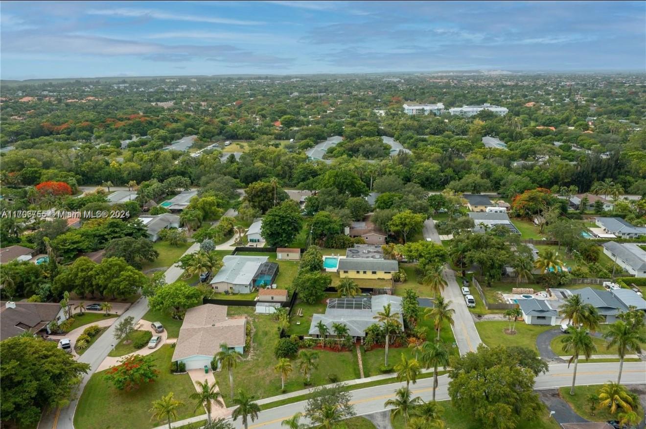 an aerial view of residential houses with city view