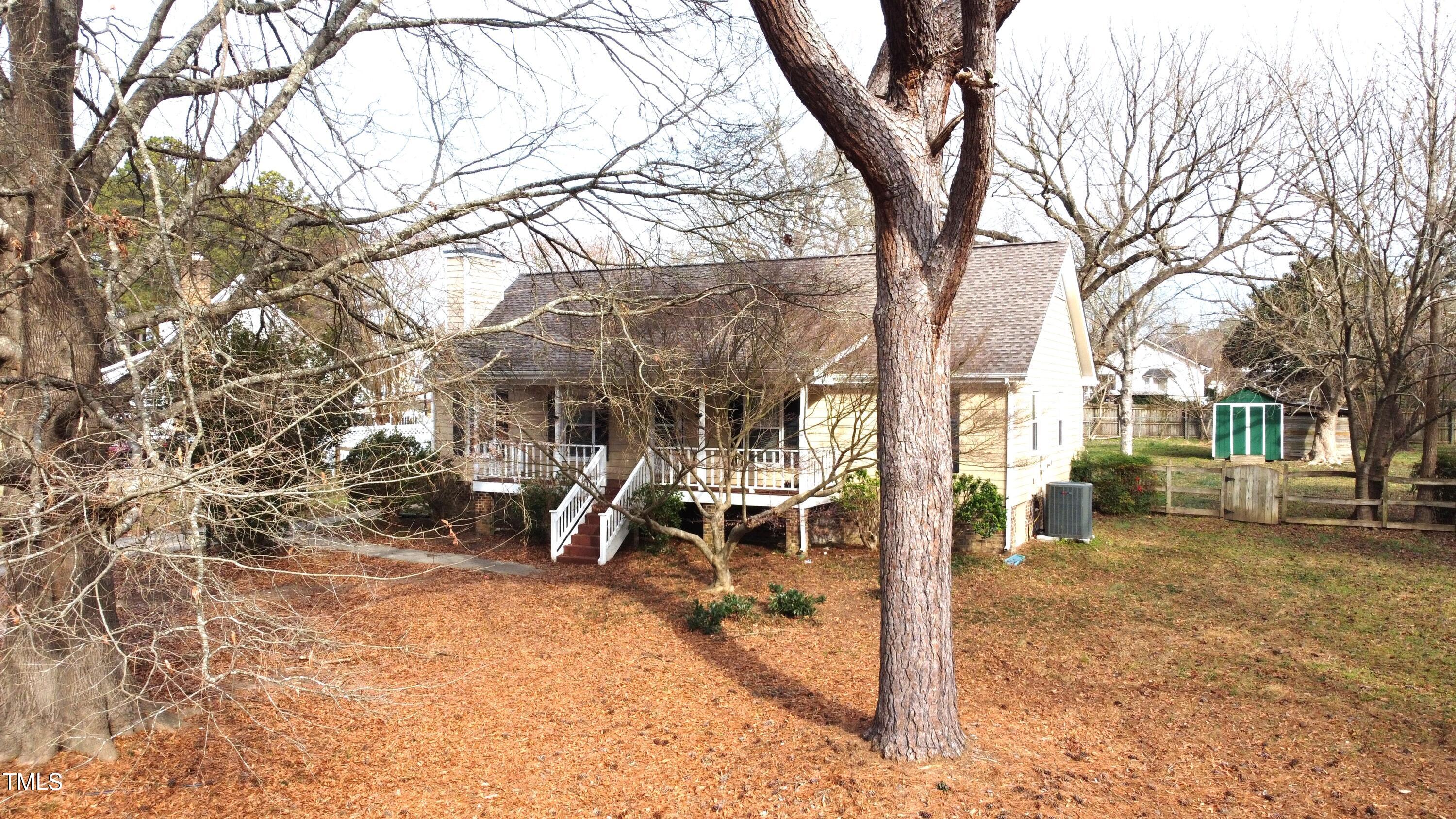 a view of a house with a yard covered in snow