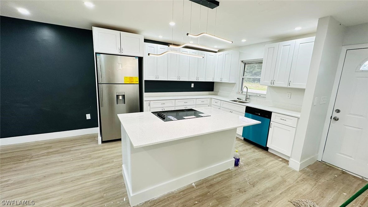 a kitchen that has a microwave a stove and a refrigerator