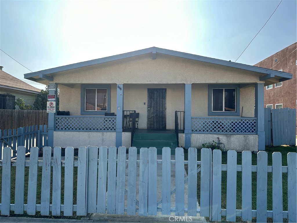 a view of a house with wooden fence