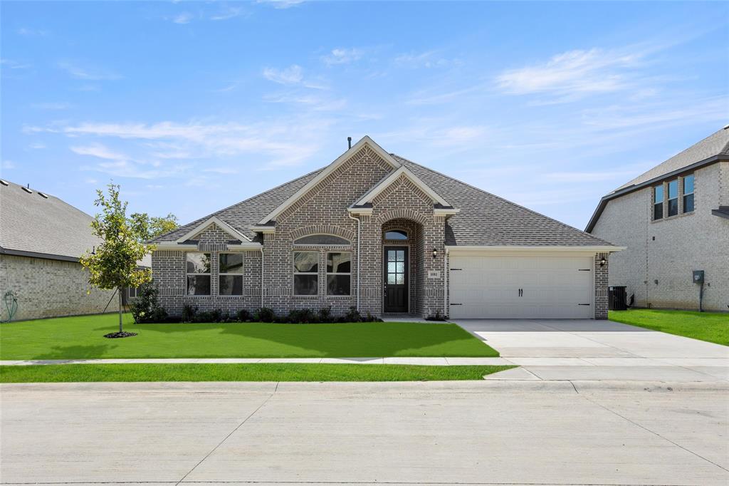 a front view of a house with a yard and garage