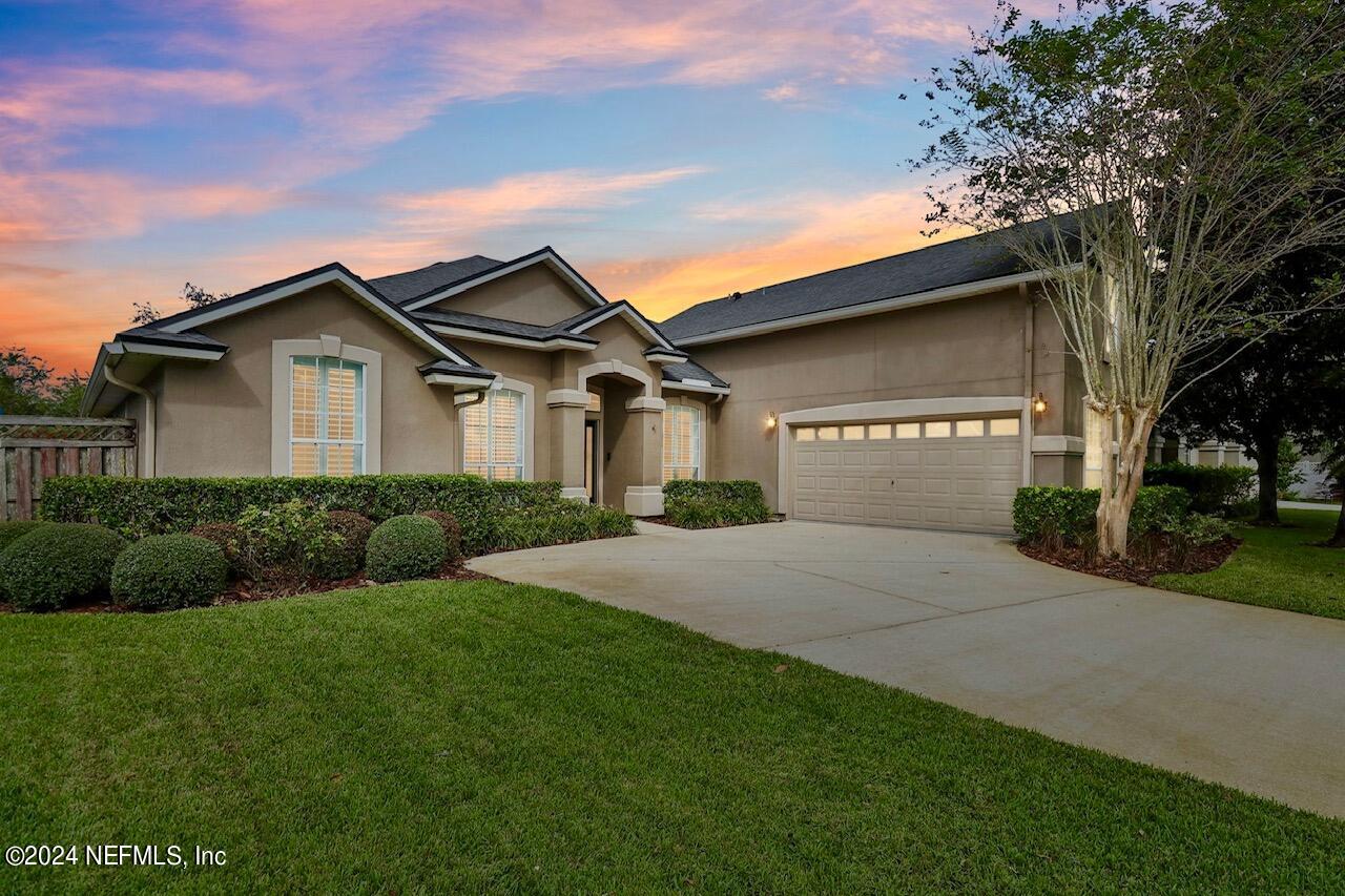 a front view of a house with a yard and garage