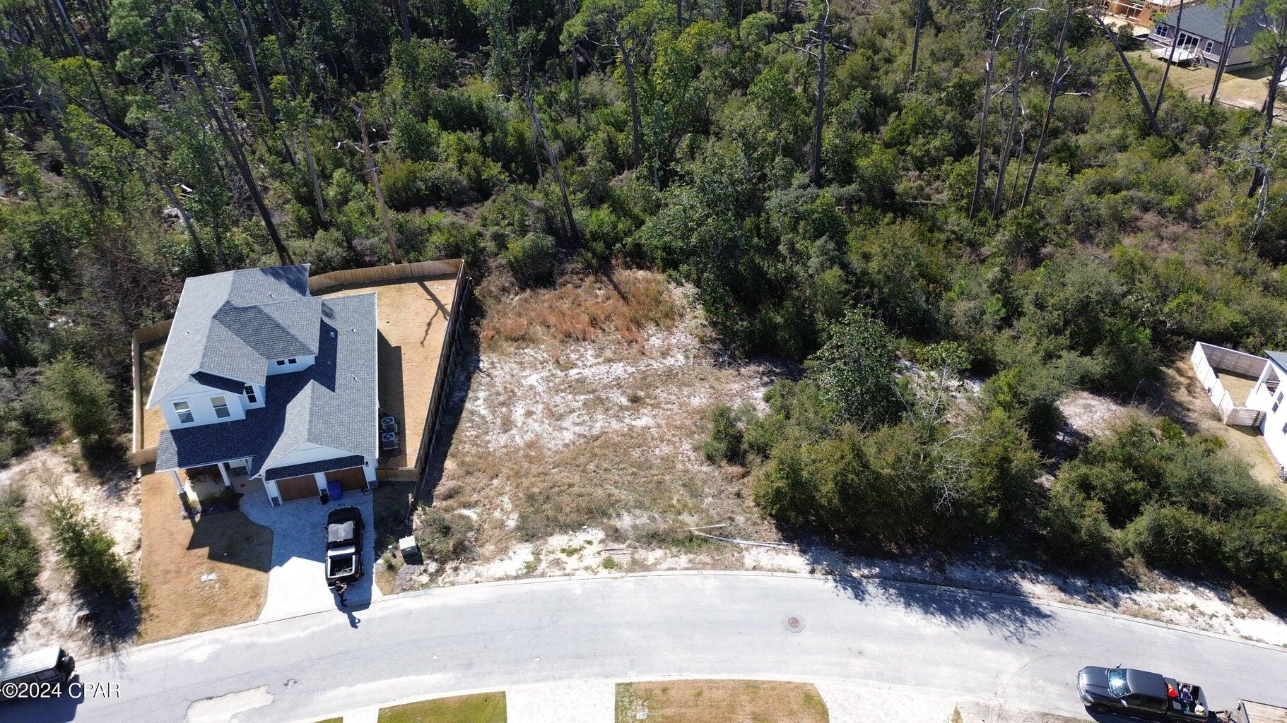 an aerial view of a house with garden space and sitting space